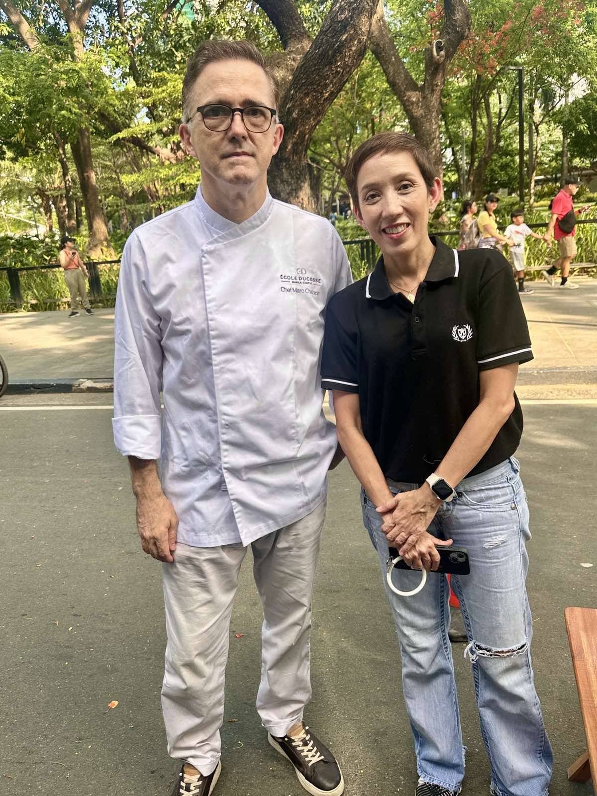 Enderun Ecole Ducasse executive chef Marc Chalopin, here with Enderun Ecole Ducasse Academic Section Head, Suzette Montinola, was at the Gôut de France’s French Market on Saturday, 1 June 2024, to prepare a special French dish in a cooking demo assisted by students from the school.